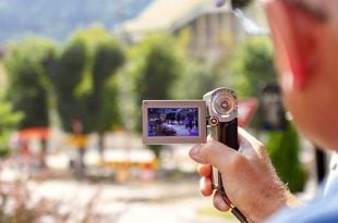 man shooting video camera